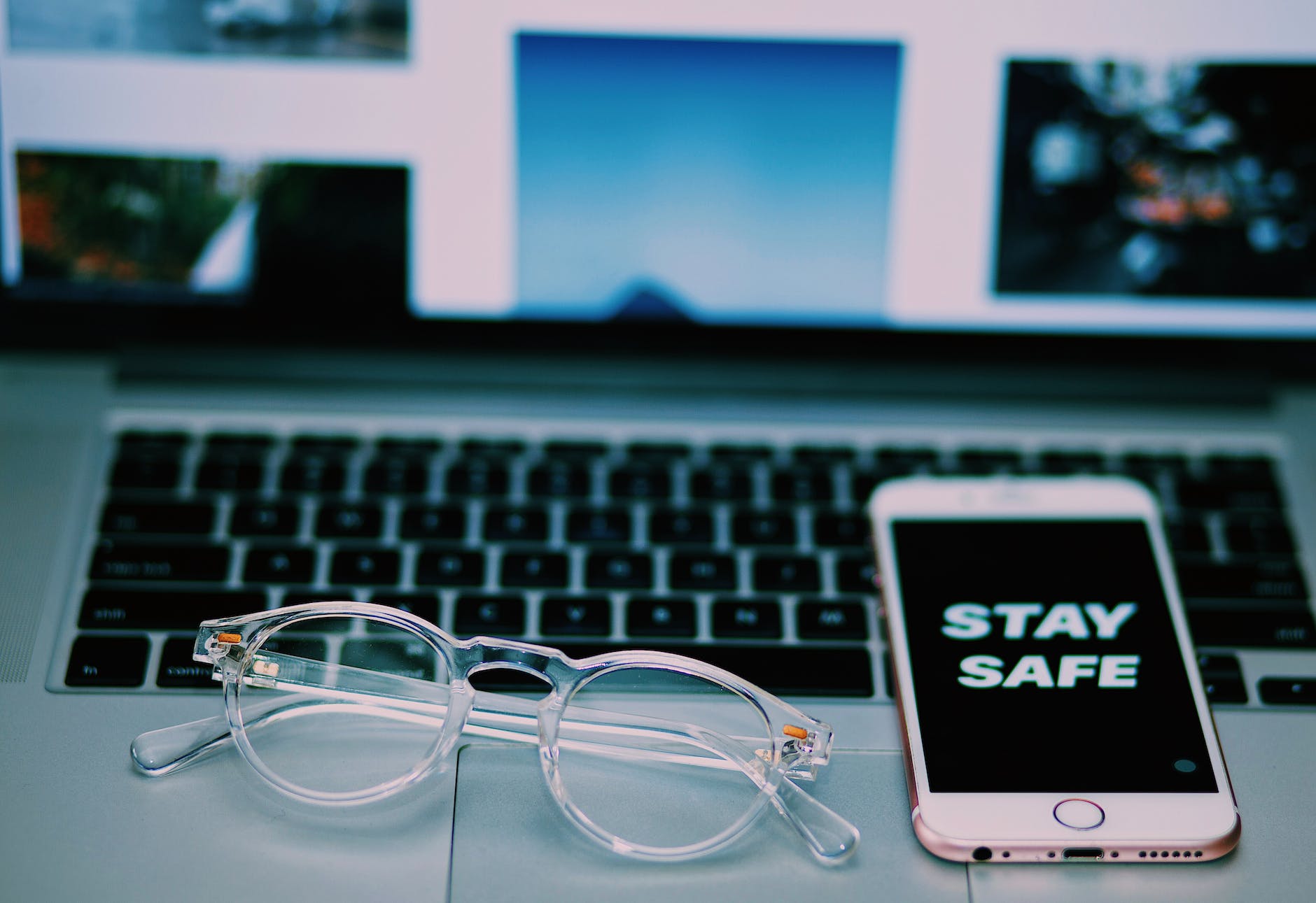 modern workplace with smartphone and laptop with glasses